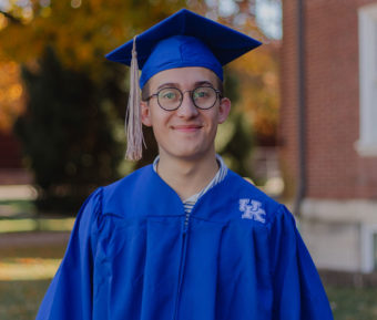 Young man wearing blue graduation cap and gown