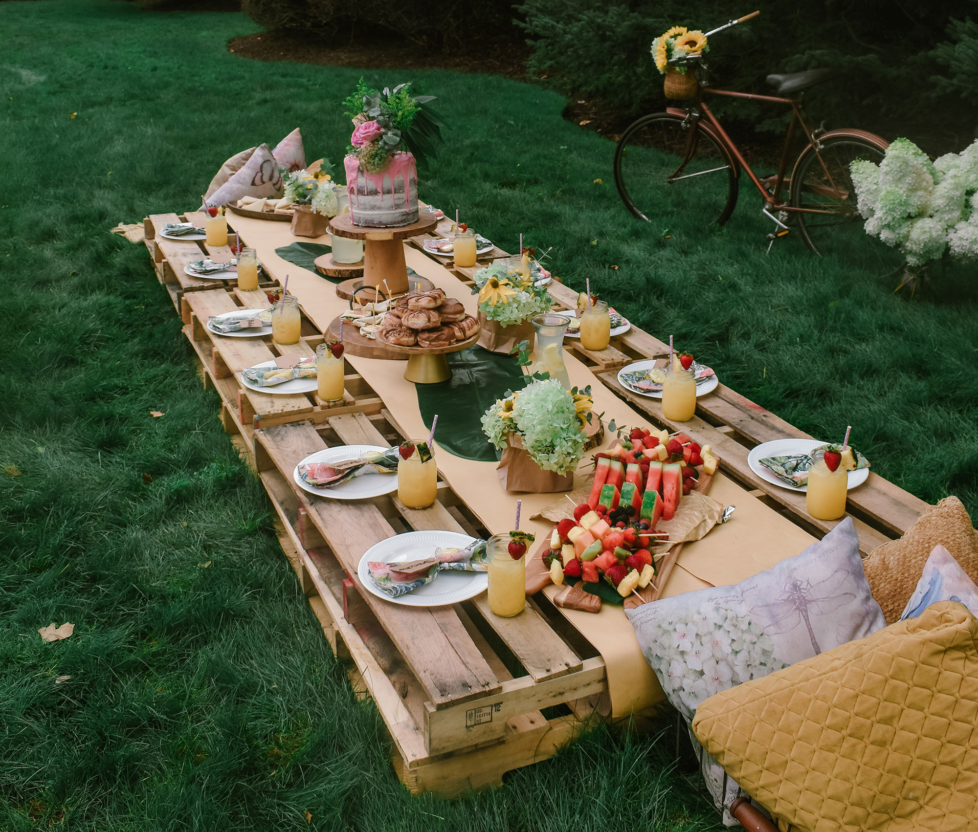 picnic table on grass with food