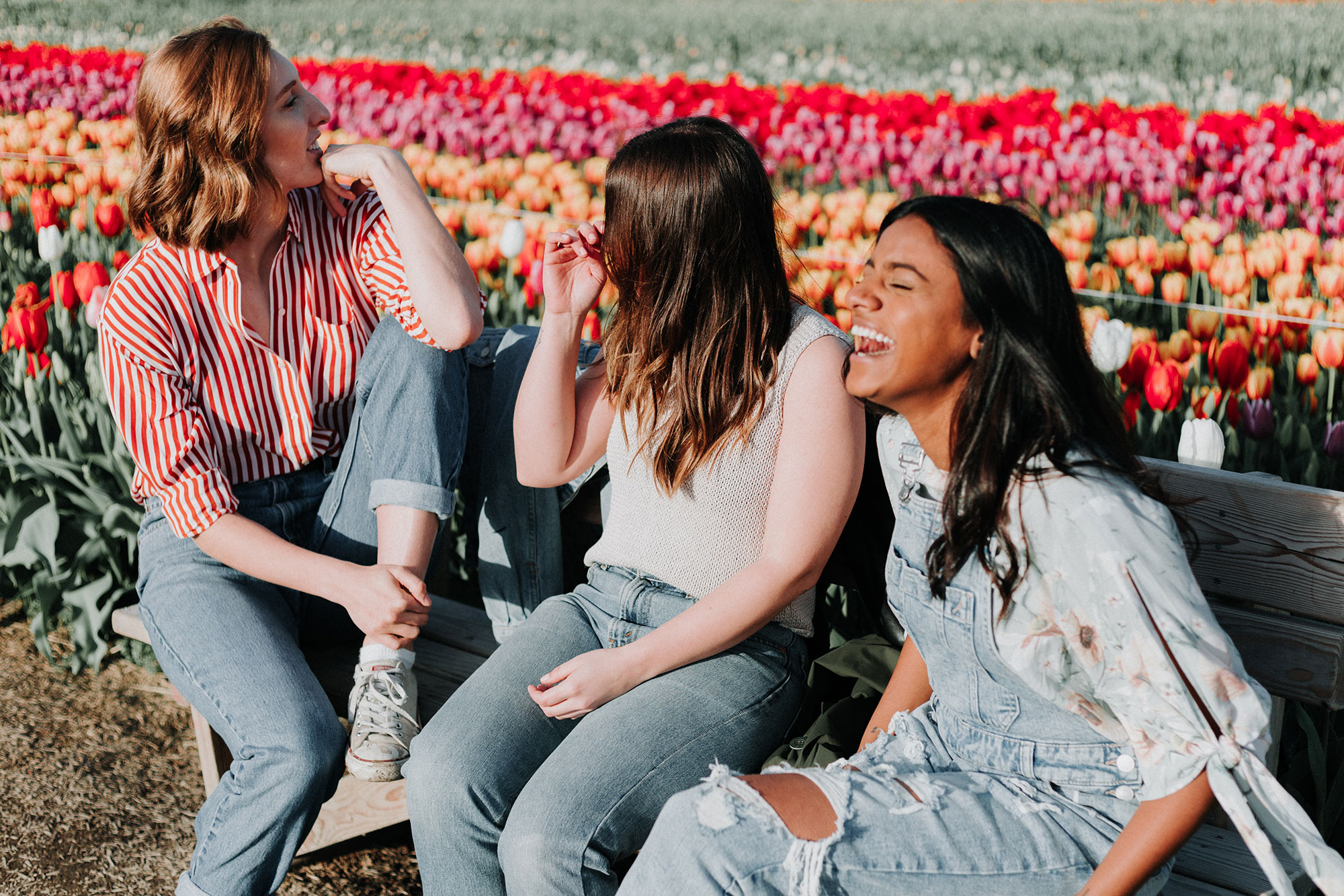 group of women talking outside by flowers